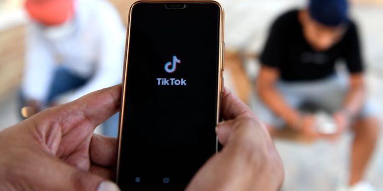 Indian mobile users browses through the Chinese owned video-sharing 'Tik Tok' app on a smartphones in Amritsar on June 30, 2020. - TikTok on June 30 denied sharing information on Indian users with the Chinese government, after New Delhi banned the wildly popular app citing national security and privacy concerns.."TikTok continues to comply with all data privacy and security requirements under Indian law and have not shared any information of our users in India with any foreign government, including the Chinese Government," said the company, which is owned by China's ByteDance. (Photo by NARINDER NANU / AFP) (Photo by NARINDER NANU/AFP via Getty Images)