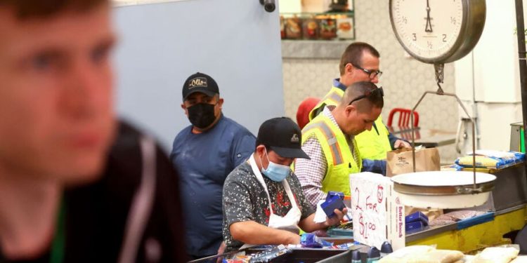 Service workers are cautious of ending mask mandates as U.S. COVID-19 cases fall