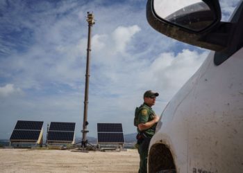 United States Border Patrol Agent Joel Freeland is pictured next to a large portable surveillance camera that is set up atop a ridge on the US-Mexico border in Sunland Park, New Mexico on September 1, 2021. (Photo by PAUL RATJE / AFP) (Photo by PAUL RATJE/AFP via Getty Images)