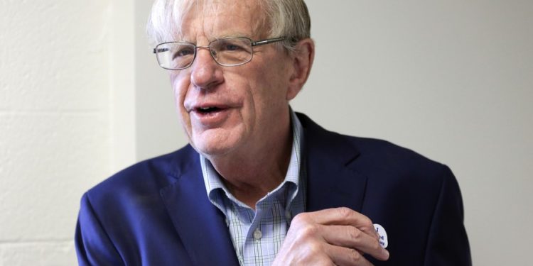 Democratic House candidate Brad Ashford puts on an "I Voted Today" sticker after casting his ballot in Omaha, Neb., Tuesday, May 15, 2018. Ashford is running against Democrat Kara Eastman in Tuesday's primary election, and the winner will challenge U.S. Rep. Don Bacon, R-Neb., after the congressman claimed the seat from Democrats two years ago. (AP Photo/Nati Harnik)