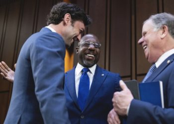 UNITED STATES - MARCH 23: From left, Sens. Jon Ossoff, D-Ga., Raphael Warnock, D-Ga., and former Sen. Doug Jones, G-Ala., talk before Judge Ketanji Brown Jackson, President Biden’s nominee for Associate Justice to the Supreme Court, arrived on the third day of her Senate Judiciary Committee confirmation hearing in Hart Senate Office Building on Capitol Hill, on Wednesday, March 23, 2022. (Tom Williams/CQ Roll Call).