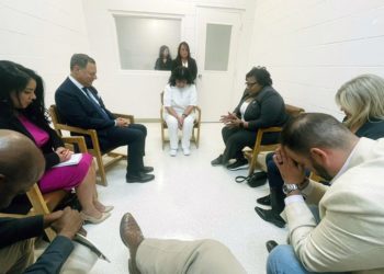 In this April 6, 2022 photo provided by Texas state Rep. Jeff Leach, Texas death row inmate Melissa Lucio, dressed in white, leads a group of seven Texas lawmakers in prayer in a room at the Mountain View Unit in Gatesville, Texas. The lawmakers visited Lucio to update her about their efforts to stop her April 27 execution. The lawmakers say they are troubled by Lucioâ€™s case and believe her execution should be stopped as there are legitimate questions about whether she is guilty. (Texas state Rep. Jeff Leach via AP)