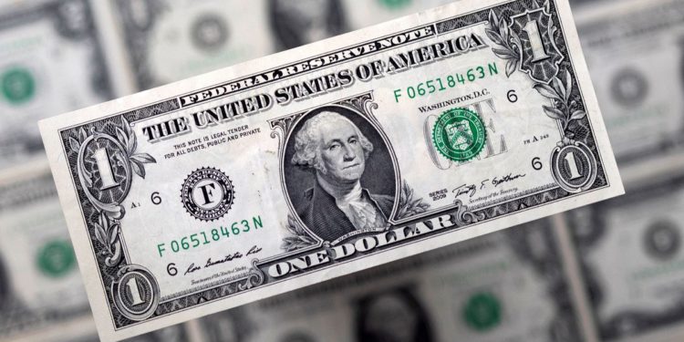 Dollar slips, still set for best month since 2015