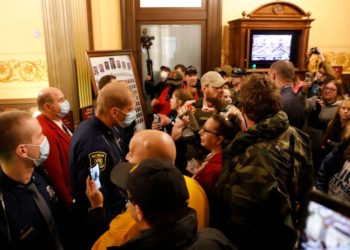 Protestors try to enter the Michigan House of Representative chamber and are being kept out by the Michigan State Police after the American Patriot Rally organized by Michigan United for Liberty protest for the reopening of businesses on the steps of the Michigan State Capitol in Lansing, Michigan on April 30, 2020. - The group is upset with Michigan Gov. Gretchen Whitmer's mandatory closure to curtail Covid-19. (Photo by JEFF KOWALSKY / AFP) (Photo by JEFF KOWALSKY/AFP via Getty Images)