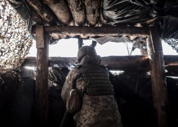 SVITLODARSK, UKRAINE - FEBRUARY 13: An Ukrainian serviceman watches DPR rebel's positions from a trench at the contact line near the village of Svitlodarsk, in Donestsk region on February 13, 2022 in Svitlodarsk, Ukraine. Russian forces are conducting large-scale military exercises in Belarus, across Ukraine's northern border, amid a tense diplomatic standoff between Russia and Ukraine's Western allies. Ukraine has warned that it is virtually encircled, with Russian troops massed on its northern, eastern and southern borders. The United States and other NATO countries have issued urgent alerts about a potential Russian invasion, hoping to deter Vladimir Putin by exposing his plans, while trying to negotiate a diplomatic solution. (Photo by Manu Brabo/Getty Images)