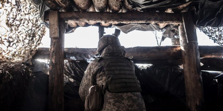 SVITLODARSK, UKRAINE - FEBRUARY 13: An Ukrainian serviceman watches DPR rebel's positions from a trench at the contact line near the village of Svitlodarsk, in Donestsk region on February 13, 2022 in Svitlodarsk, Ukraine. Russian forces are conducting large-scale military exercises in Belarus, across Ukraine's northern border, amid a tense diplomatic standoff between Russia and Ukraine's Western allies. Ukraine has warned that it is virtually encircled, with Russian troops massed on its northern, eastern and southern borders. The United States and other NATO countries have issued urgent alerts about a potential Russian invasion, hoping to deter Vladimir Putin by exposing his plans, while trying to negotiate a diplomatic solution. (Photo by Manu Brabo/Getty Images)