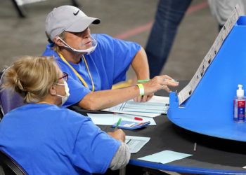 Maricopa County ballots cast in the 2020 general election are examined and recounted by contractors working for Florida-based company, Cyber Ninjas, Thursday, May 6, 2021 at Veterans Memorial Coliseum in Phoenix. The audit, ordered by the Arizona Senate, has the U.S. Department of Justice saying it is concerned about ballot security and potential voter intimidation arising from the unprecedented private recount of the 2020 presidential election results. (AP Photo/Matt York, Pool)