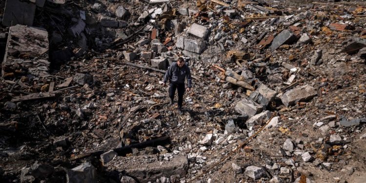 TOPSHOT - A policeman walks among the rubble of destroyed houses in Bohdanivka village, northeast of Kyiv, on April 14, 2022, amid Russia's invasion launched on Ukraine. (Photo by FADEL SENNA / AFP) (Photo by FADEL SENNA/AFP via Getty Images)