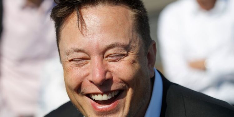 Tesla CEO Elon Musk laughs as he talks to media as he arrives to visit the construction site of the future US electric car giant Tesla, on September 03, 2020 in Gruenheide near Berlin. - Tesla builds a compound at the site in Gruenheide in Brandenburg for its first European "Gigafactory" near Berlin. (Photo by Odd ANDERSEN / AFP) (Photo by ODD ANDERSEN/AFP via Getty Images)