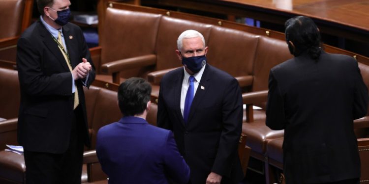 WASHINGTON, DC - JANUARY 06: Vice President Mike Pence returns to Senate chamber to debate the Pennsylvania objection in the House Chamber during a reconvening of a joint session of Congress on January 06, 2021 in Washington, DC. Members of Congress returned to the House Chamber after being evacuated when protesters stormed the Capitol and disrupted a joint session to ratify President-elect Joe Biden's 306-232 Electoral College win over President Donald Trump. (Photo by Win McNamee/Getty Images)