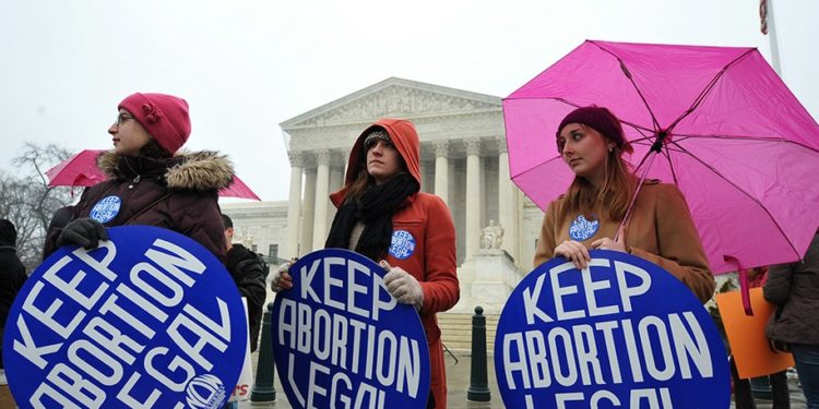 Pro-choice activists hold placards during a rally outside of the Supreme Court January 23, 2012 in Washington, DC. Activists on both sides of the abortion issue are rallying on the 39th anniversary of the landmark Roe vs Wade case. AFP PHOTO/Mandel NGAN (Photo by Mandel NGAN / AFP) (Photo by MANDEL NGAN/AFP via Getty Images)