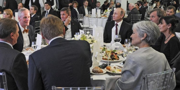 FILE- In this file photo taken on Thursday, Dec. 10, 2015, Russian President Vladimir Putin, center right, with retired U.S. Lt. Gen. Michael T. Flynn, center left, and Serbian filmmaker Emir Kusturica, obscured second right, attend an exhibition marking the 10th anniversary of RT (Russia Today) 24-hour English-language TV news channel in Moscow, Russia. Flynn is widely reported Thursday Nov. 17, 2016, to be a potential contender to become national security advisor to U.S. president elect Donald Trump, although his appointment may be controversial. (Mikhail Klimentyev/Sputnik, Kremlin Pool Photo via AP, file)