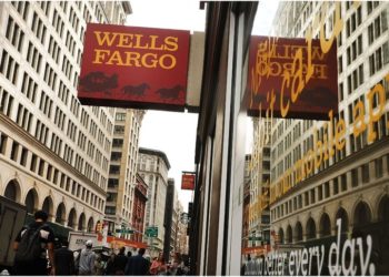 People walk by a Wells Fargo bank branch on October 13, 2017 in New York City.