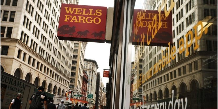 People walk by a Wells Fargo bank branch on October 13, 2017 in New York City.