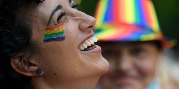 A woman takes part in a Pride march in Madrid on July 3, 2021. - The slogan of 2021's march is  Human rights are not negotiated, they are legislated: Trans Law Now. The march, which have a limited capacity, without any floats and demanding equal rights for the LGBTQ community. (Photo by OSCAR DEL POZO / AFP) (Photo by OSCAR DEL POZO/AFP via Getty Images)