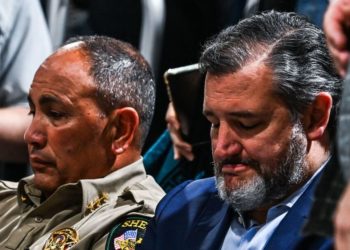 Uvalde County Sheriff Ruben Nolasco (L) and US Senator Ted Cruz (R) a Republican from Texas, look on as they attends a vigil for the victims of the mass shooting at Robb Elementary School in Uvalde, Texas on May 25, 2022. - The tight-knit Latino community of Uvalde was wracked with grief Wednesday after a teen in body armor marched into the school and killed 19 children and two teachers, in the latest spasm of deadly gun violence in the US. (Photo by CHANDAN KHANNA / AFP) (Photo by CHANDAN KHANNA/AFP via Getty Images)