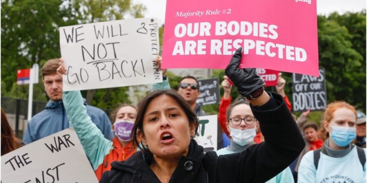 Marchers hold up signs during a Mothers Day rally in support of abortion rights at the U.S. Supreme Court on May 8, 2022 in Washington, D.C.