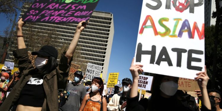 LOS ANGELES, CALIFORNIA - MARCH 27: People demonstrate against anti-Asian violence and racism on March 27, 2021 in Los Angeles, California. March 27 is the #StopAsianHate National Day of Action against anti-Asian violence. On March 16th, eight people were killed at three Atlanta-area spas, six of whom were Asian women, in an attack that sent fear through the Asian community amid a rise in anti-Asian hate crimes. (Photo by Mario Tama/Getty Images)
