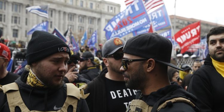 Leader of the Proud Boys, Enrique Tarrio speaks with one of his members in Freedom Plaza on December 12, 2020 in Washington DC.. Backers continue to support the President's unproven claims of massive voter fraud and electoral irregularities. Following the November MAGA rally in Washington, Women For America First, a conservative organization, has filed for another permit to rally in support of President Trump, just two days before the electors form each state are to vote for their candidate. (Photo by John Lamparski/SIPA USA)(Sipa via AP Images)
