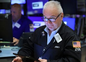 Stocks gyrate, dollar gains as Fed keeps hawkish stance