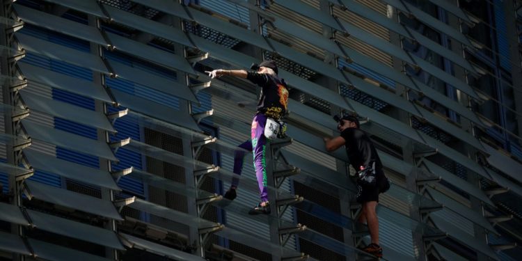 ‘French Spiderman’ climbs first skyscraper with son in Barcelona