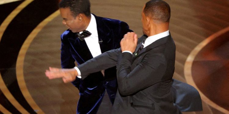 Chris Rock unleashes on Will Smith and wife Jada a year after Oscars slap