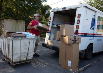 WINTERVILLE, GA - SEPTEMBER 22: Postman Robert Nagel loads packages onto a mail truck outside the post office in Winterville, Georgia.(Dustin Chambers for The Washington Post via Getty Images)