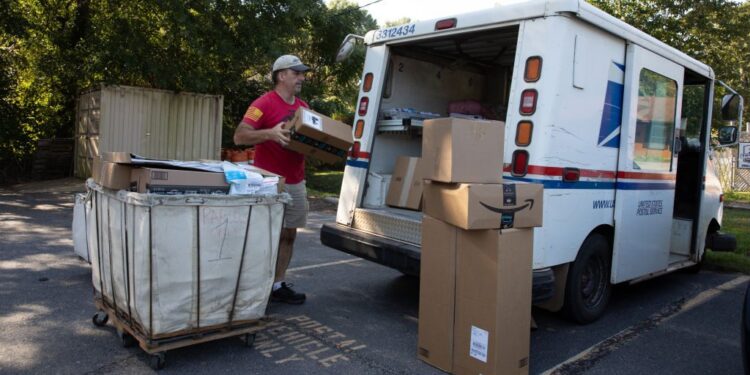 WINTERVILLE, GA - SEPTEMBER 22: Postman Robert Nagel loads packages onto a mail truck outside the post office in Winterville, Georgia.(Dustin Chambers for The Washington Post via Getty Images)